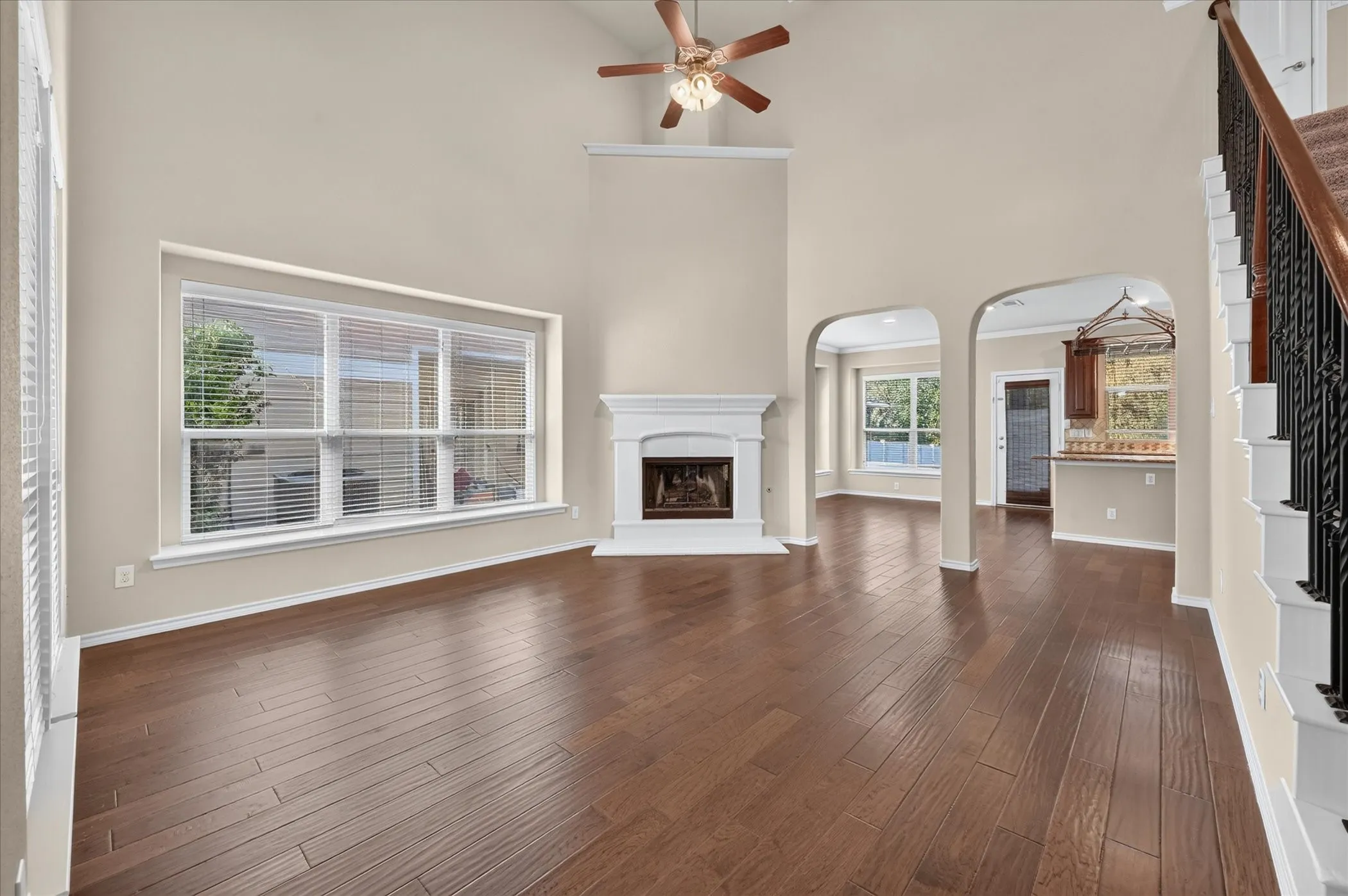 Expansive living area featuring soaring ceilings and wood-finish flooring