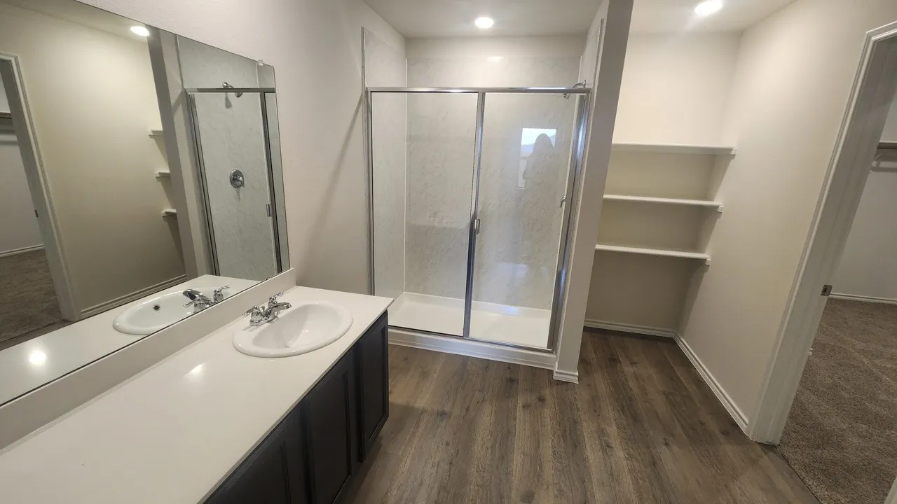 Vanity with an integrated sink and an expansive mirror
