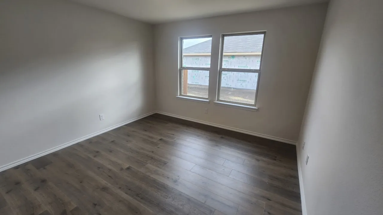 Wood-finish flooring with white trim and a neutral color palette