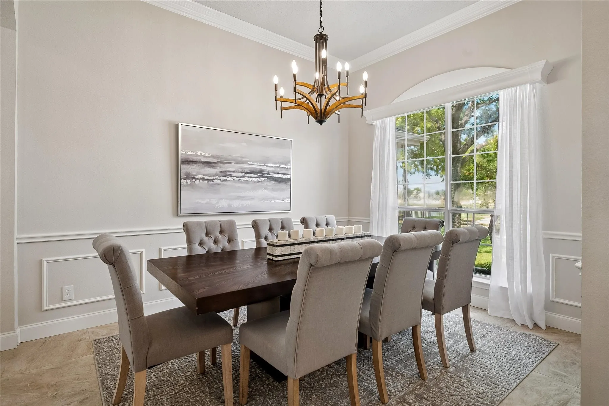 Crown molding, wainscoting, and large picture window