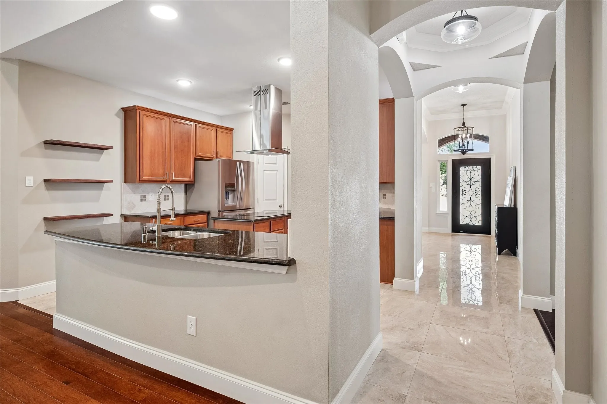 Kitchen featuring wood cabinetry, stainless steel appliances, and dark countertops