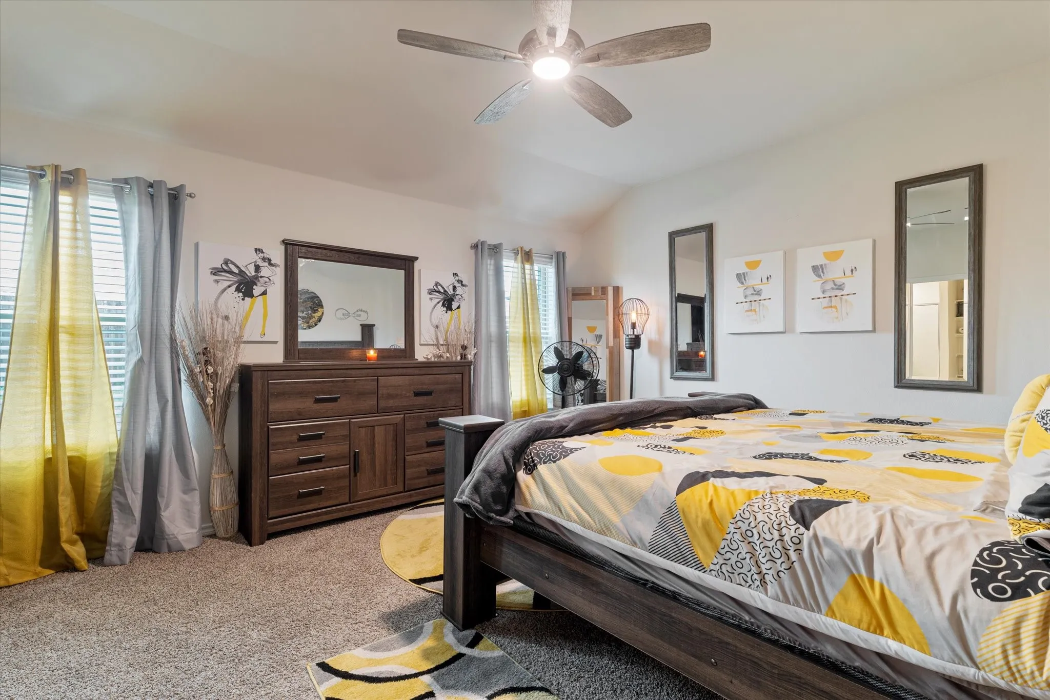 Bedroom featuring light carpet, lofted ceiling, and ceiling fan