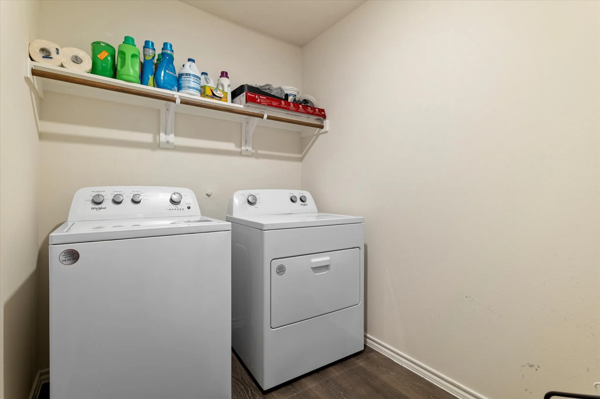 Laundry area featuring washing machine and dryer and dark wood-type flooring
