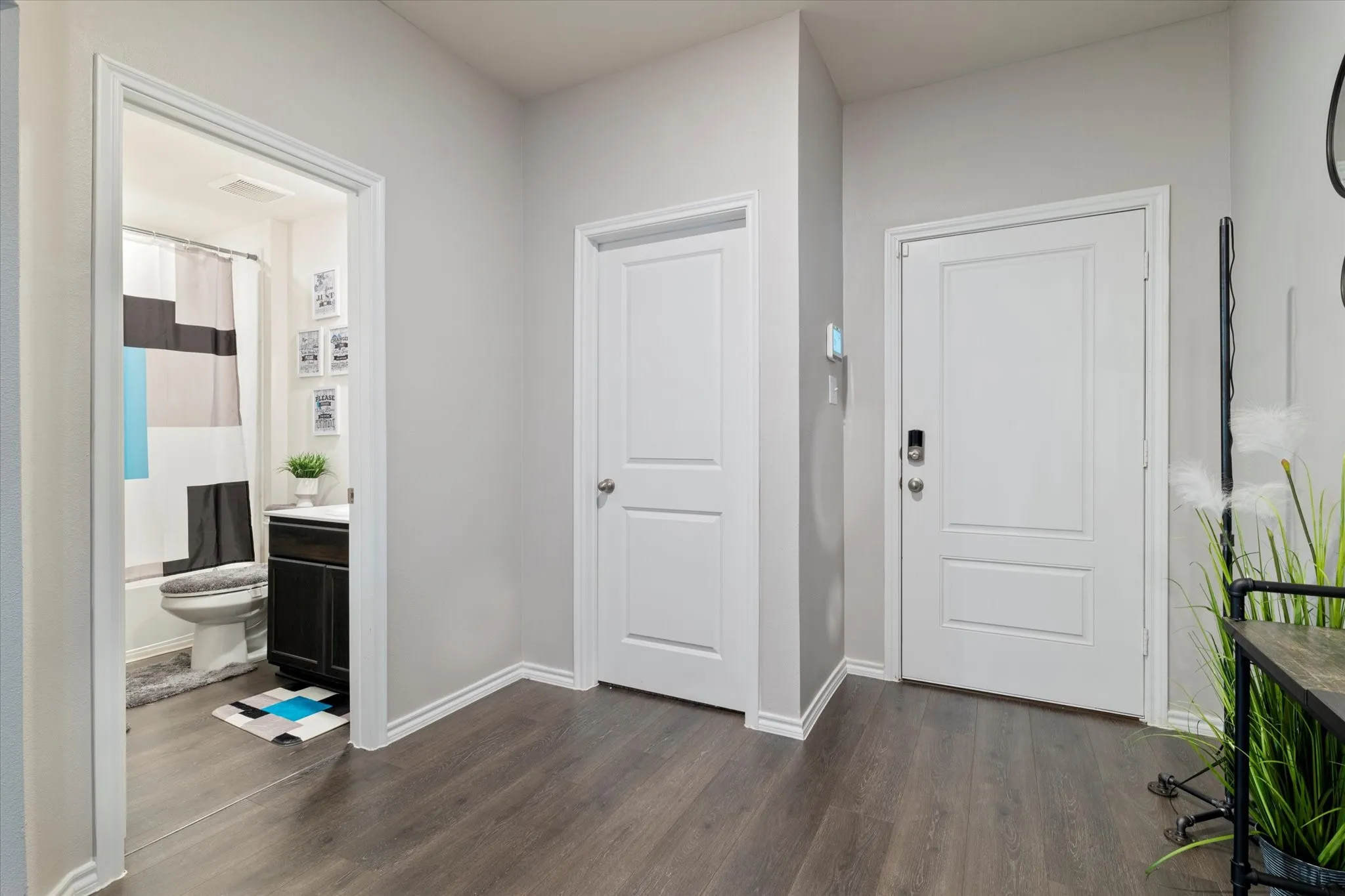 Entryway featuring baseboards and dark wood finished floors
