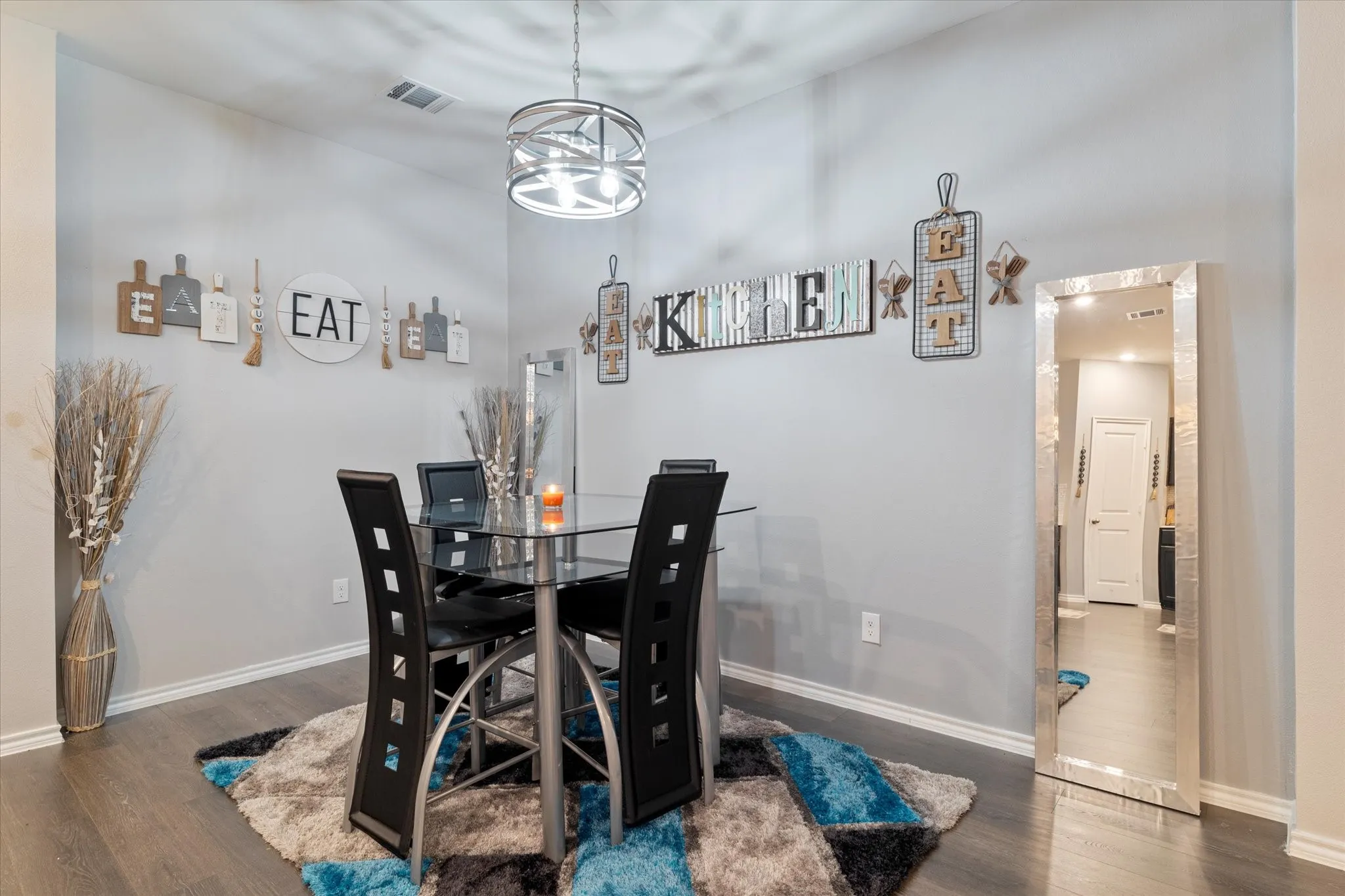 Dining area featuring dark wood-style floors and baseboards