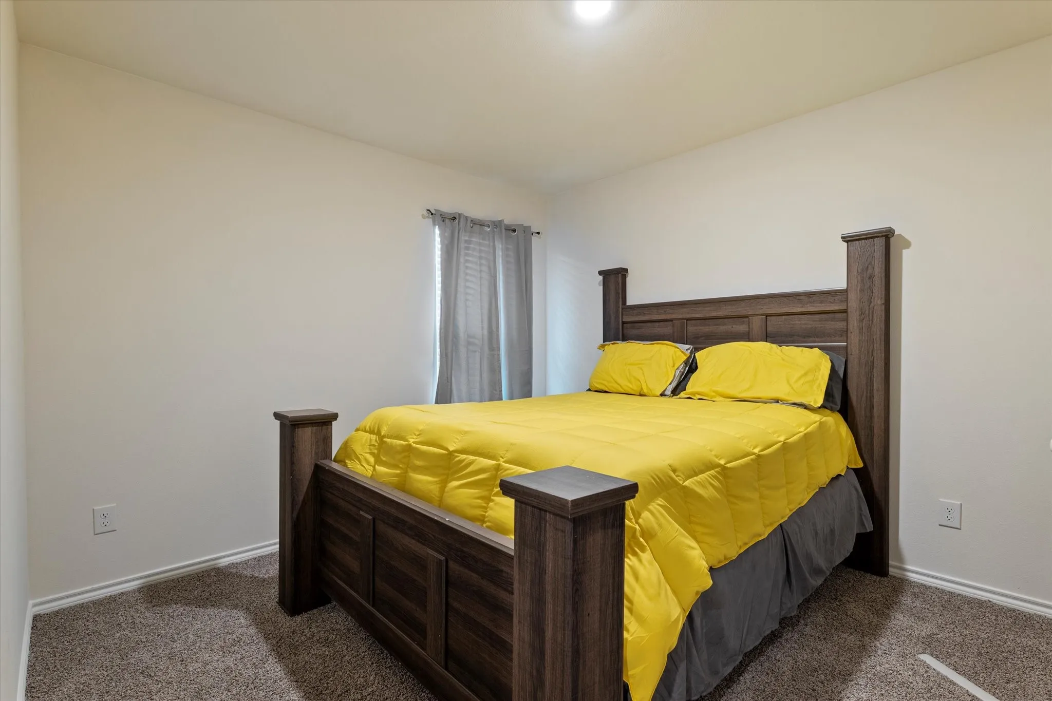 Bedroom featuring dark colored carpet