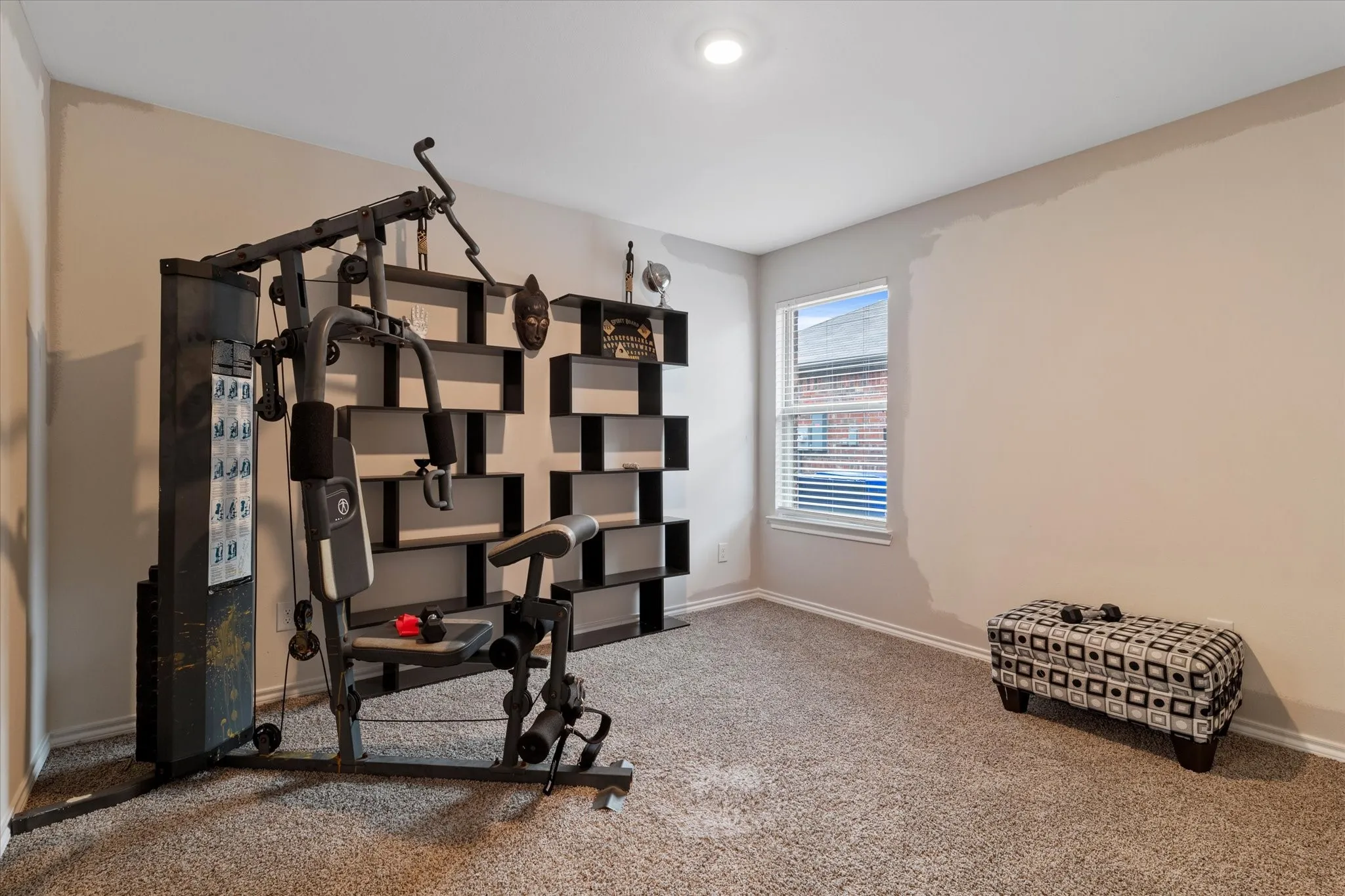 Exercise area featuring carpet and baseboards