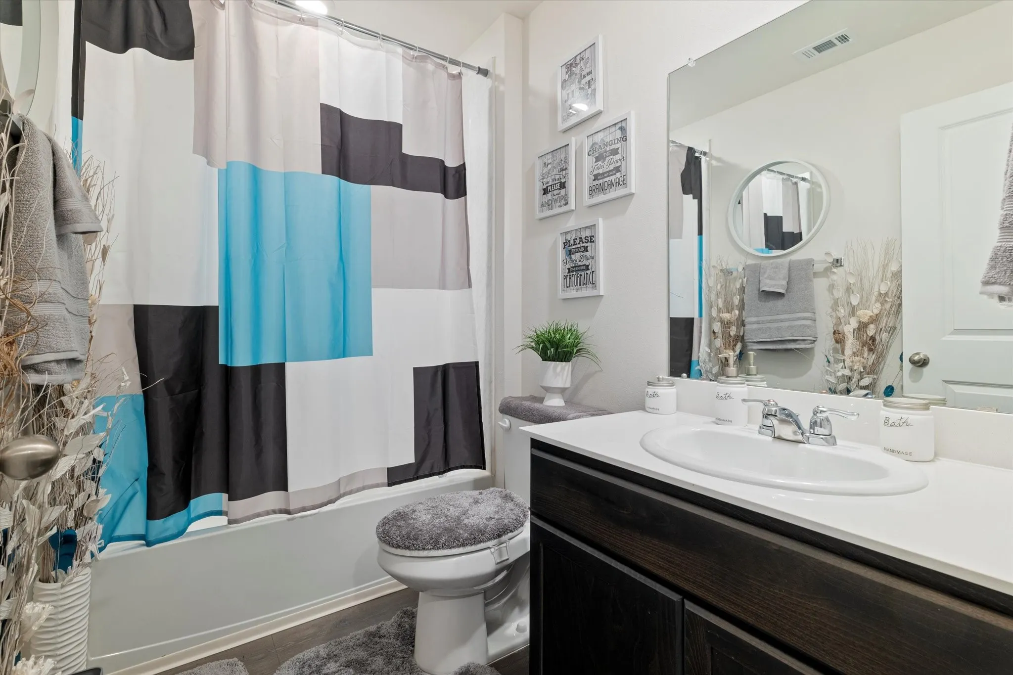 Bathroom with shower / bathtub combination with curtain and vanity