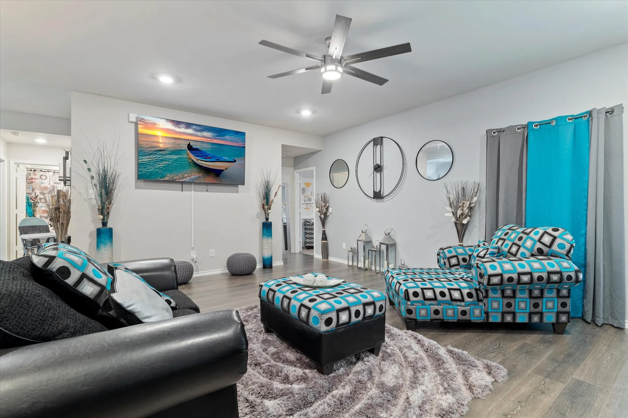 Living area featuring wood finished floors, a ceiling fan, and recessed lighting