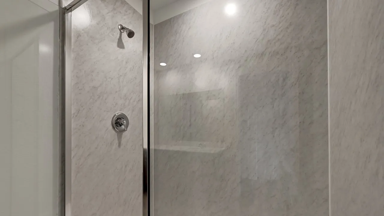Shower enclosure with a chrome shower head and control