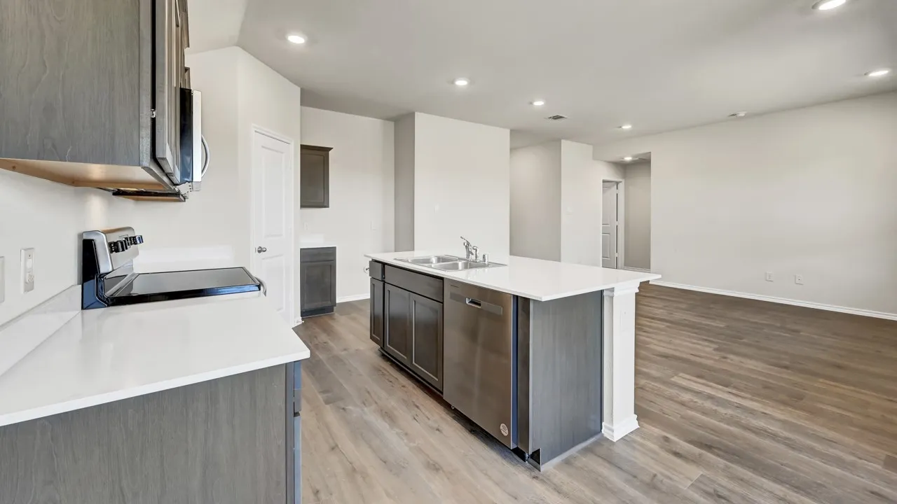 Kitchen with white countertops, wood-finish flooring, recessed lighting, and stainless steel appliances