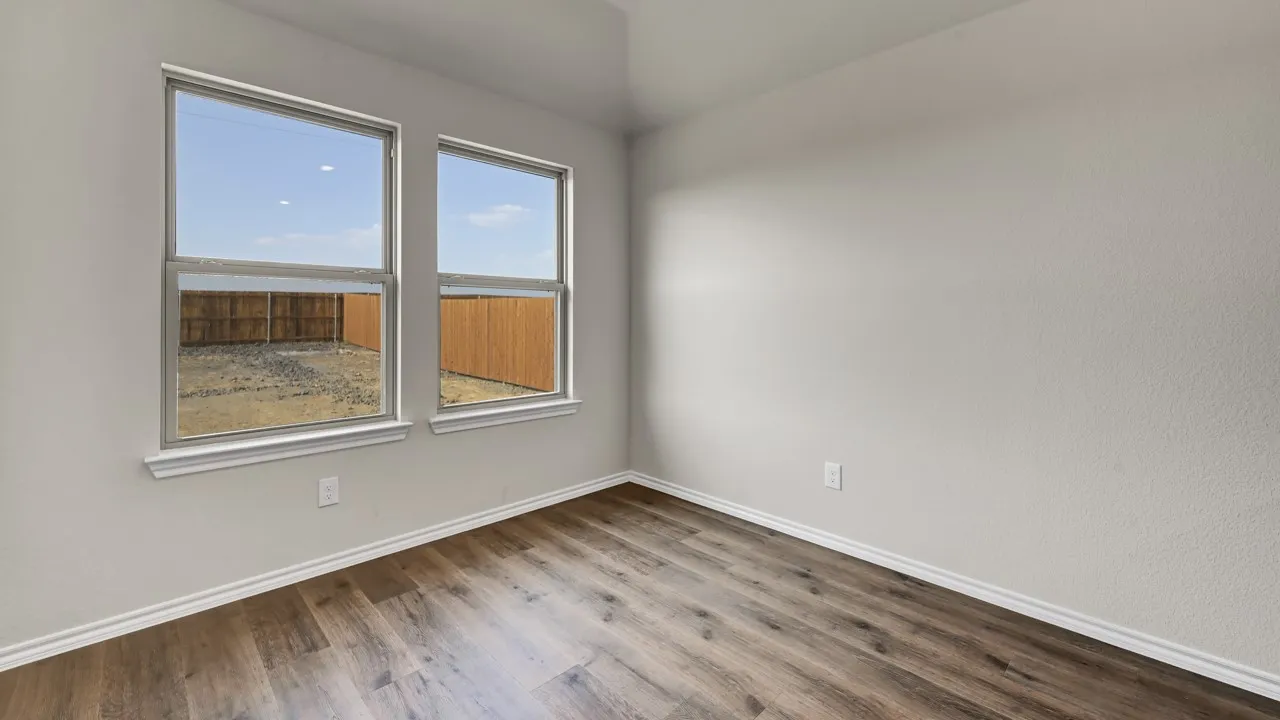 Wood-finish flooring with white trim and neutral wall tones