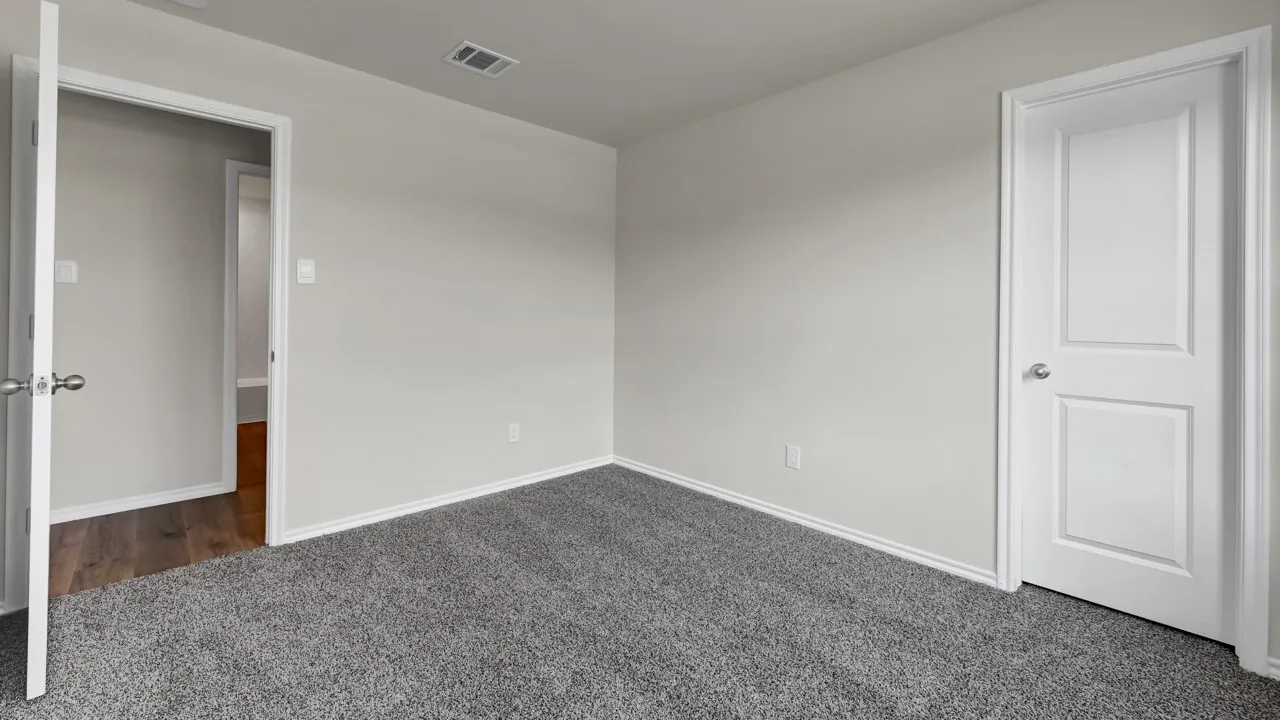 Grey carpeting with light neutral wall paint
