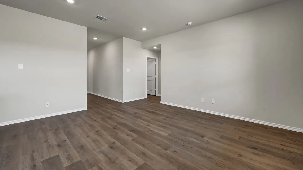 Wood-finish flooring with recessed lighting and neutral wall tones