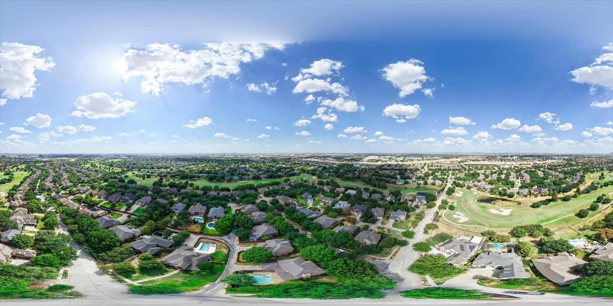 Expansive residential area featuring numerous mature trees, visible golf course, and a variety of detached homes