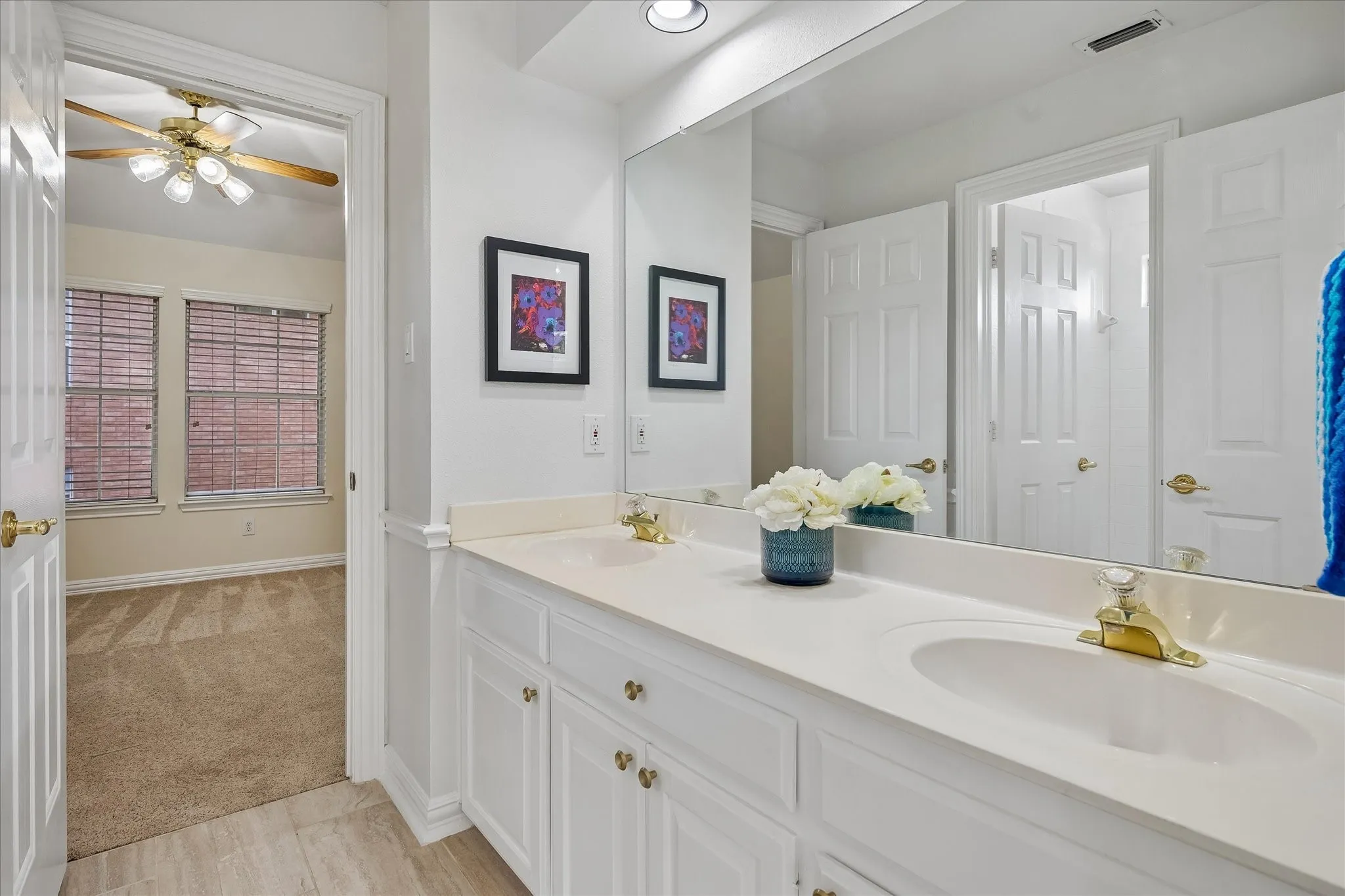 Double vanity with integrated sinks and brass-finish faucets
