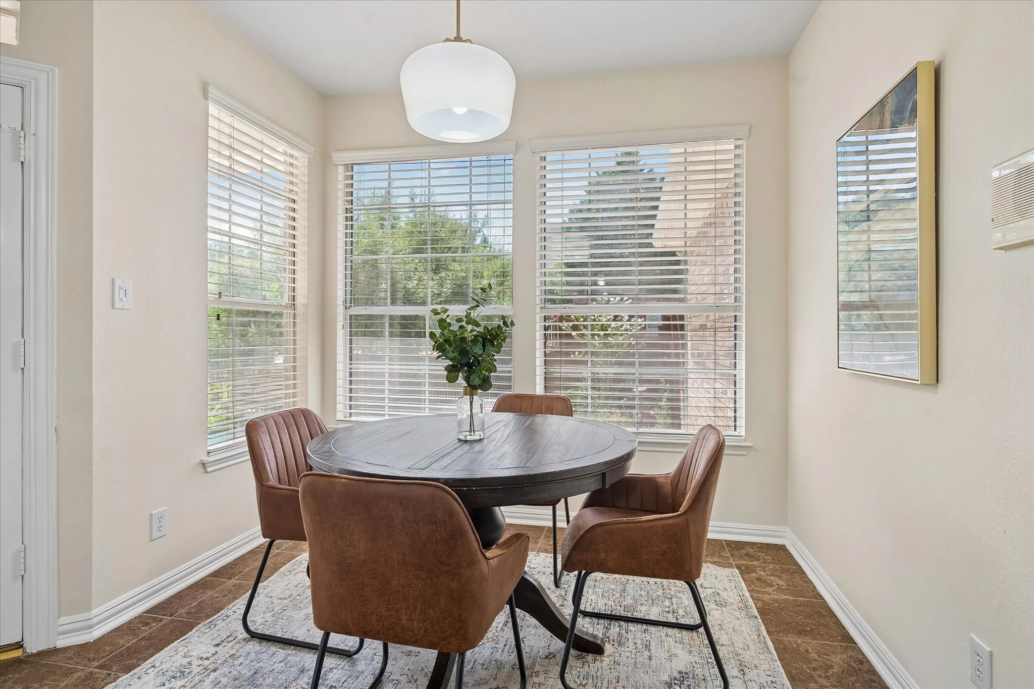 Recessed lighting fixtures, multiple windows with blinds, and tile flooring