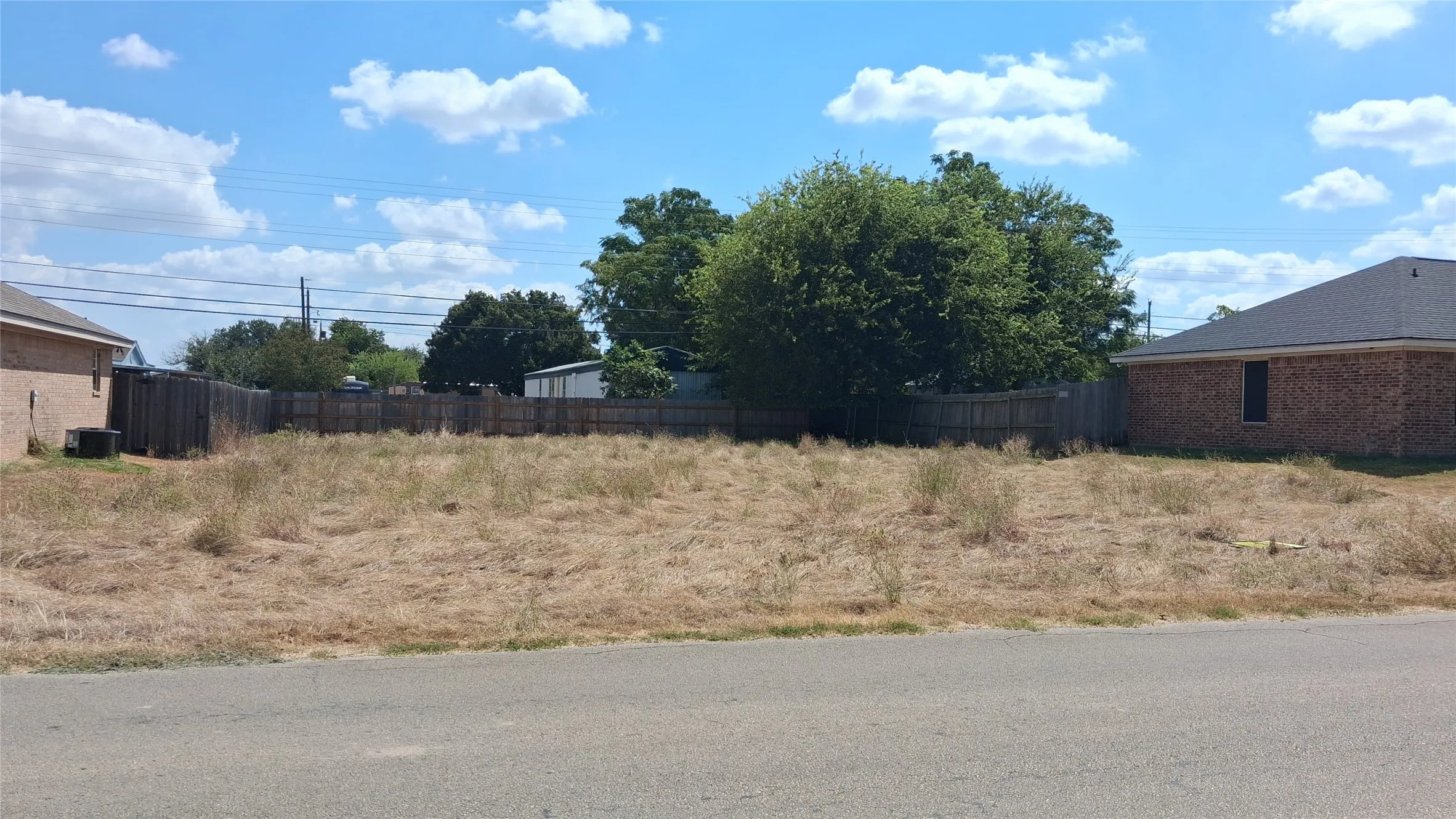 Fenced perimeter, existing asphalt street frontage