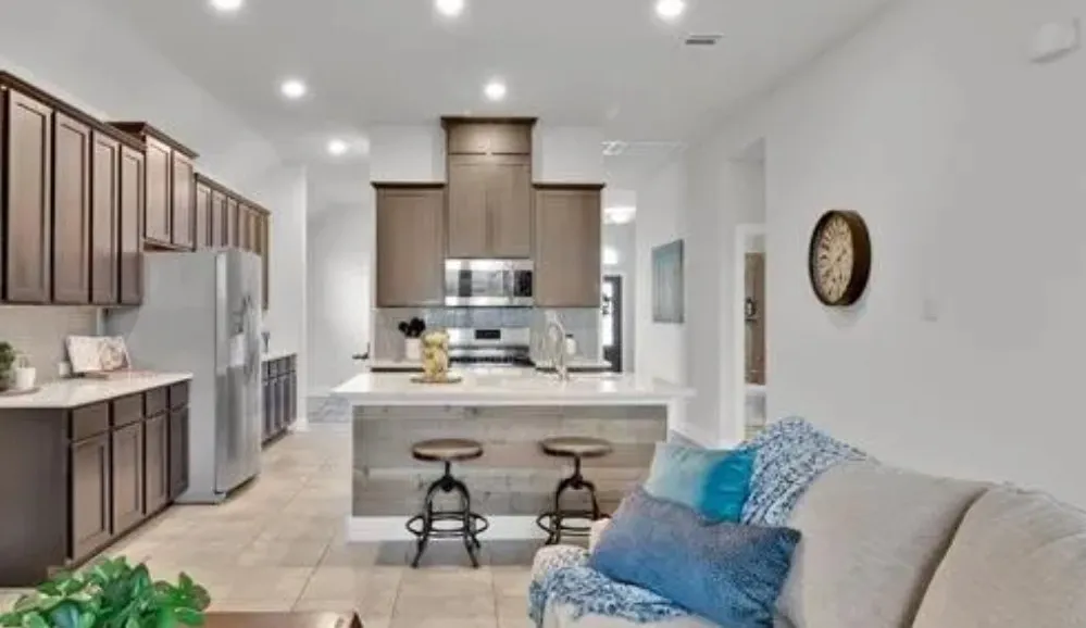Open-concept living space with recessed lighting and neutral wall tones