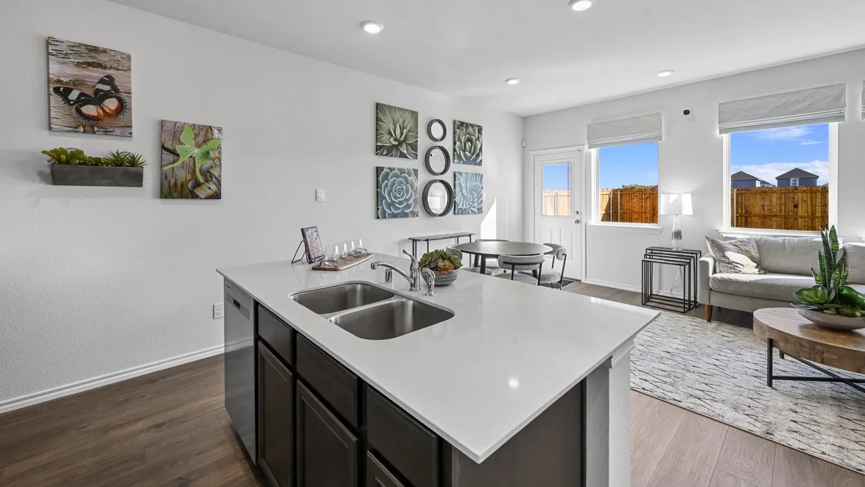 Kitchen island with dual stainless steel sinks and a light-toned countertop