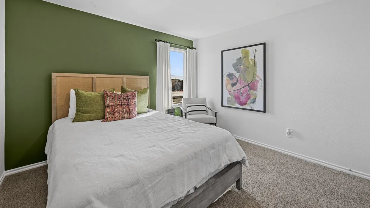 Carpeted flooring, window with white drapery, and a painted accent wall