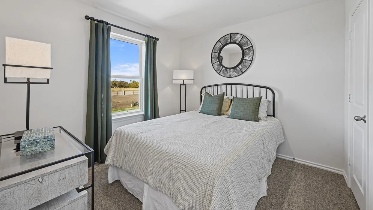 White walls with a single window and dark curtains