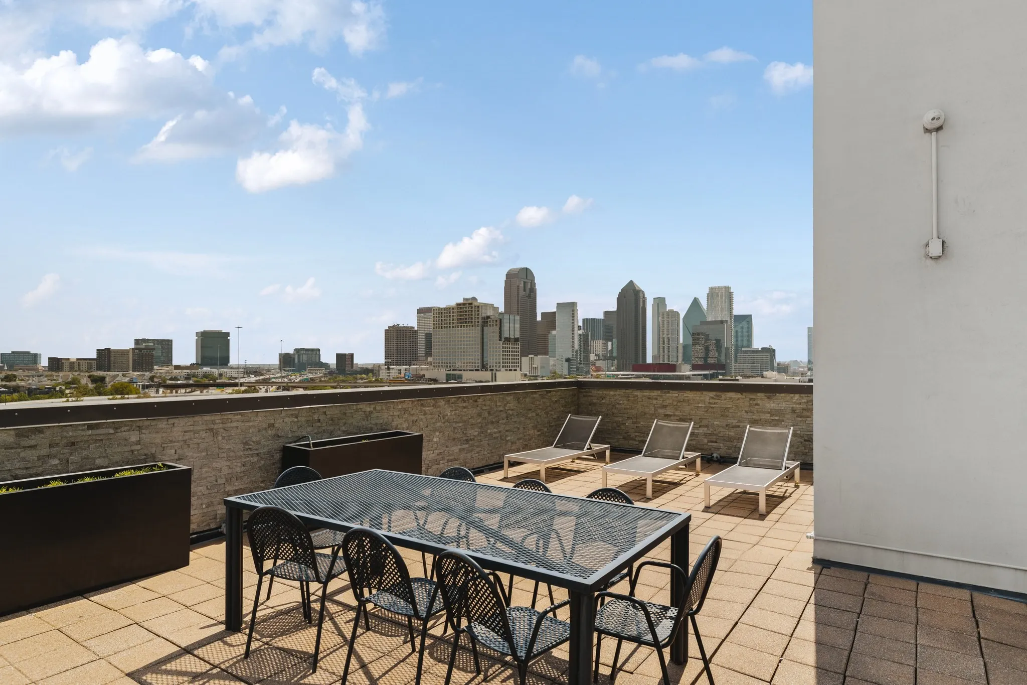 Rooftop terrace with paver flooring and cityscape backdrop
