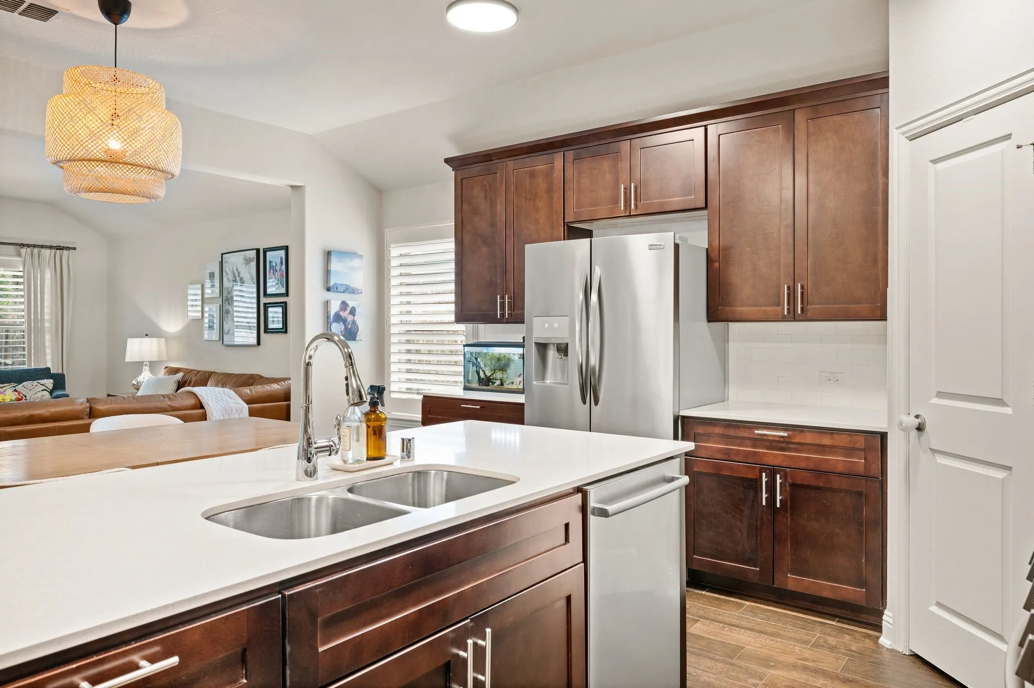 Kitchen with beautiful wood cabinetry, stainless steel appliances, quartz countertops and large island with extra seating!