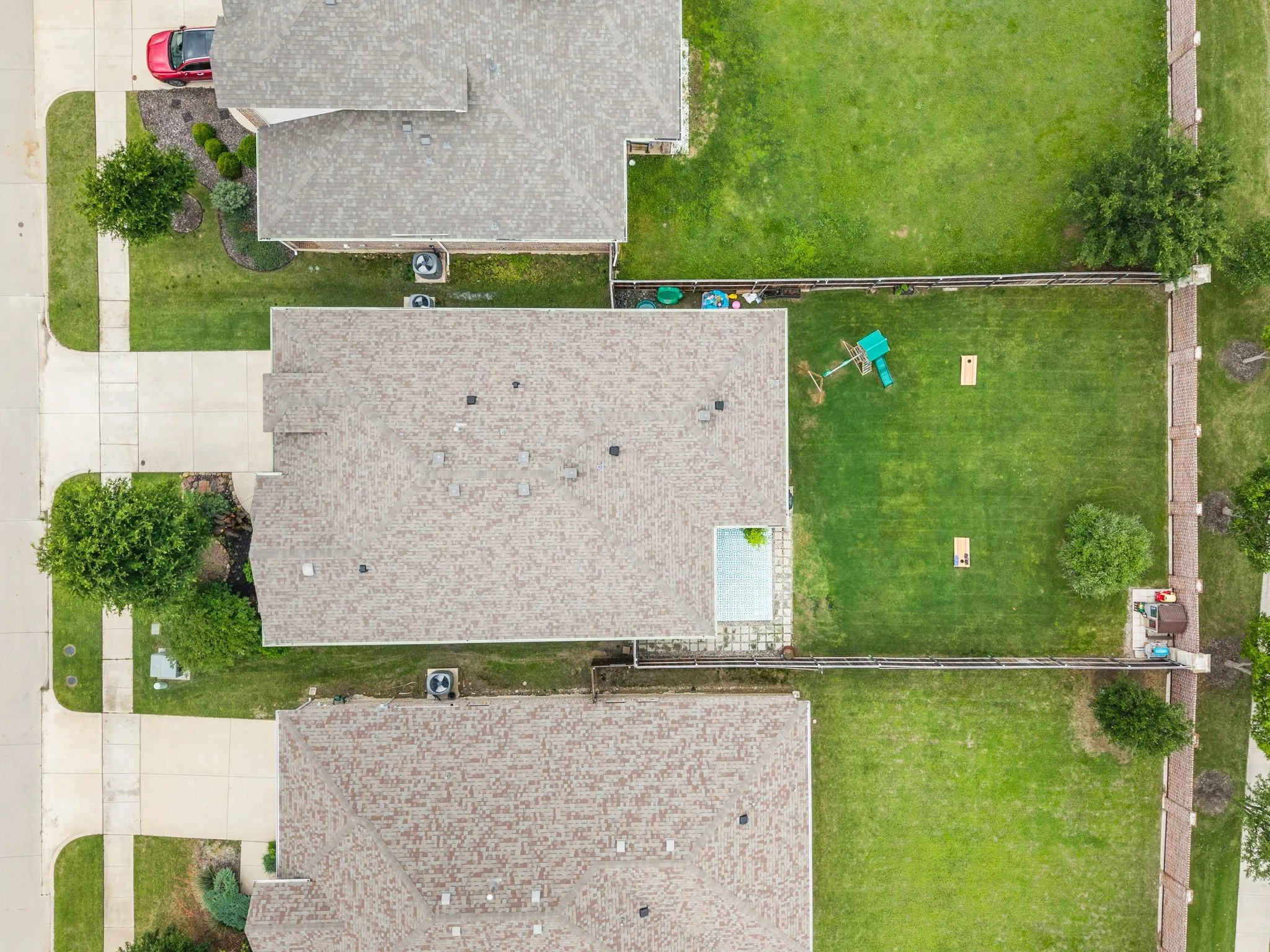 Expansive backyard featuring a manicured lawn, established trees, and a privacy fence...Ready to make this your home?