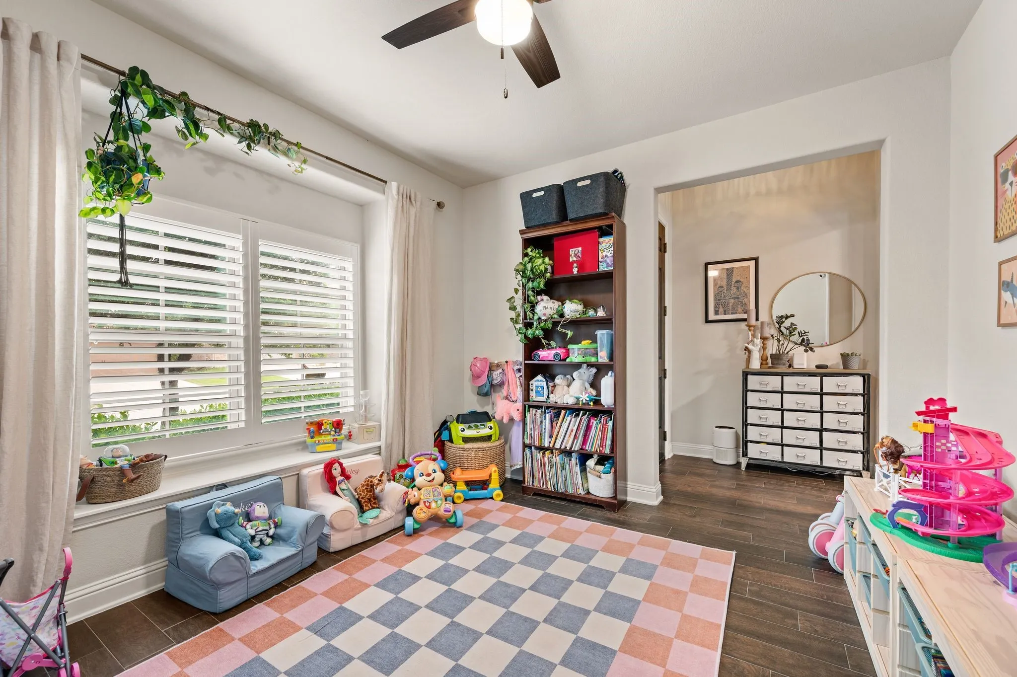 Updated flooring and  white plantation shutters, built-in window seating,  and a overhead ceiling fan make this flex space a perfect spot for a game room, second living room room or even a fabulous large office space.  Come see how this space would be perfect for you!