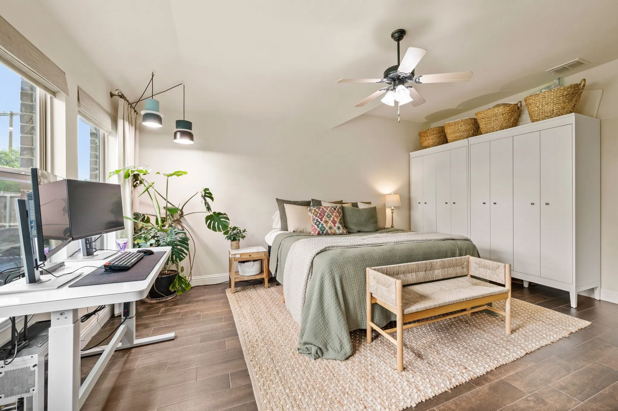 beautiful updated flooring throughout, bright windows with custom curtains and romans shades, ceiling fan, recessed lighting, and lots of room for your large primary bedroom furniture