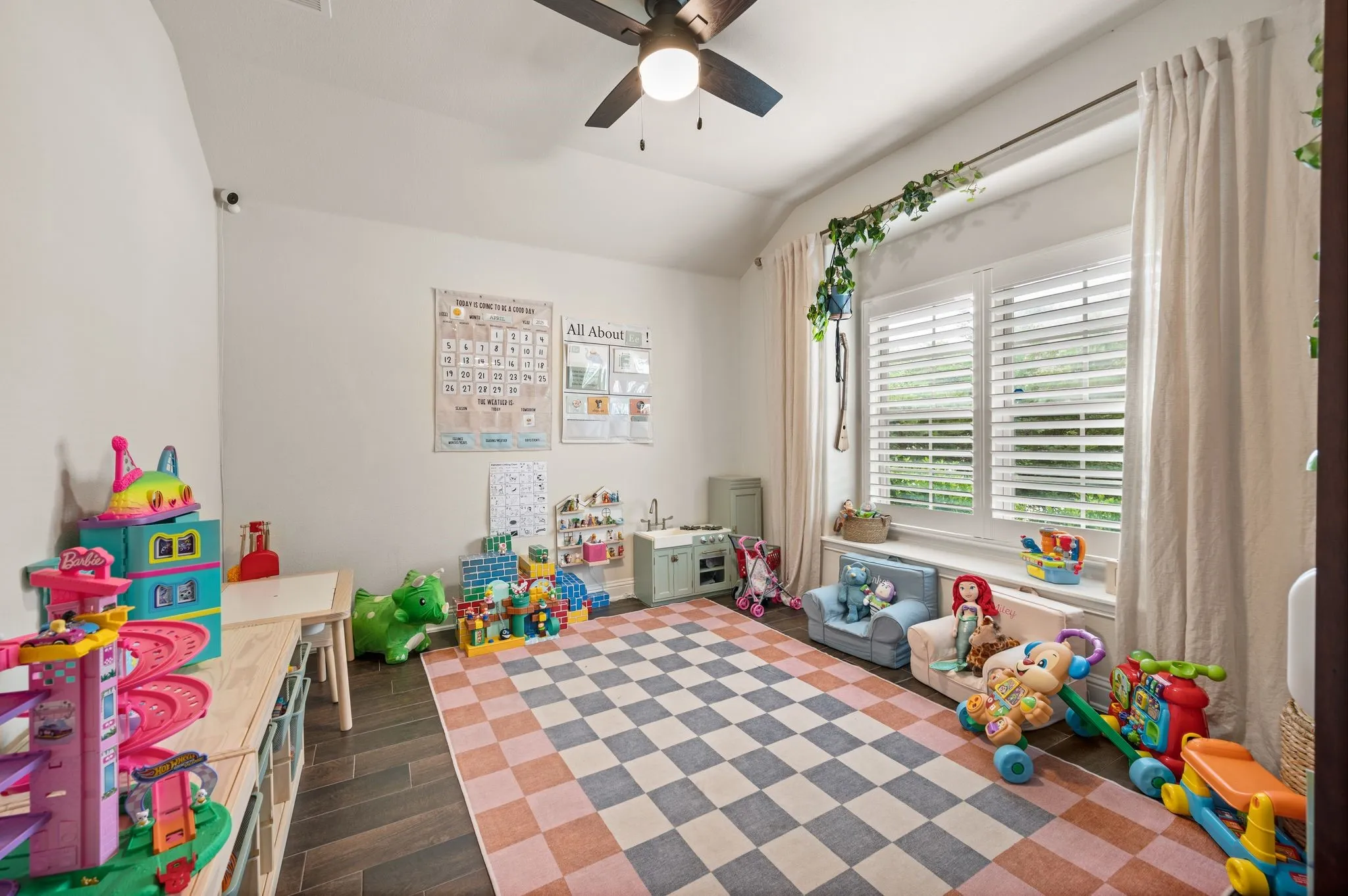 Vaulted ceiling with a ceiling fan, dual windows with upgragded plantation shutters, curtains that will stay with the home and updated flooring.  This flex room can be an office, game room, or second living room...What will you want it to be?