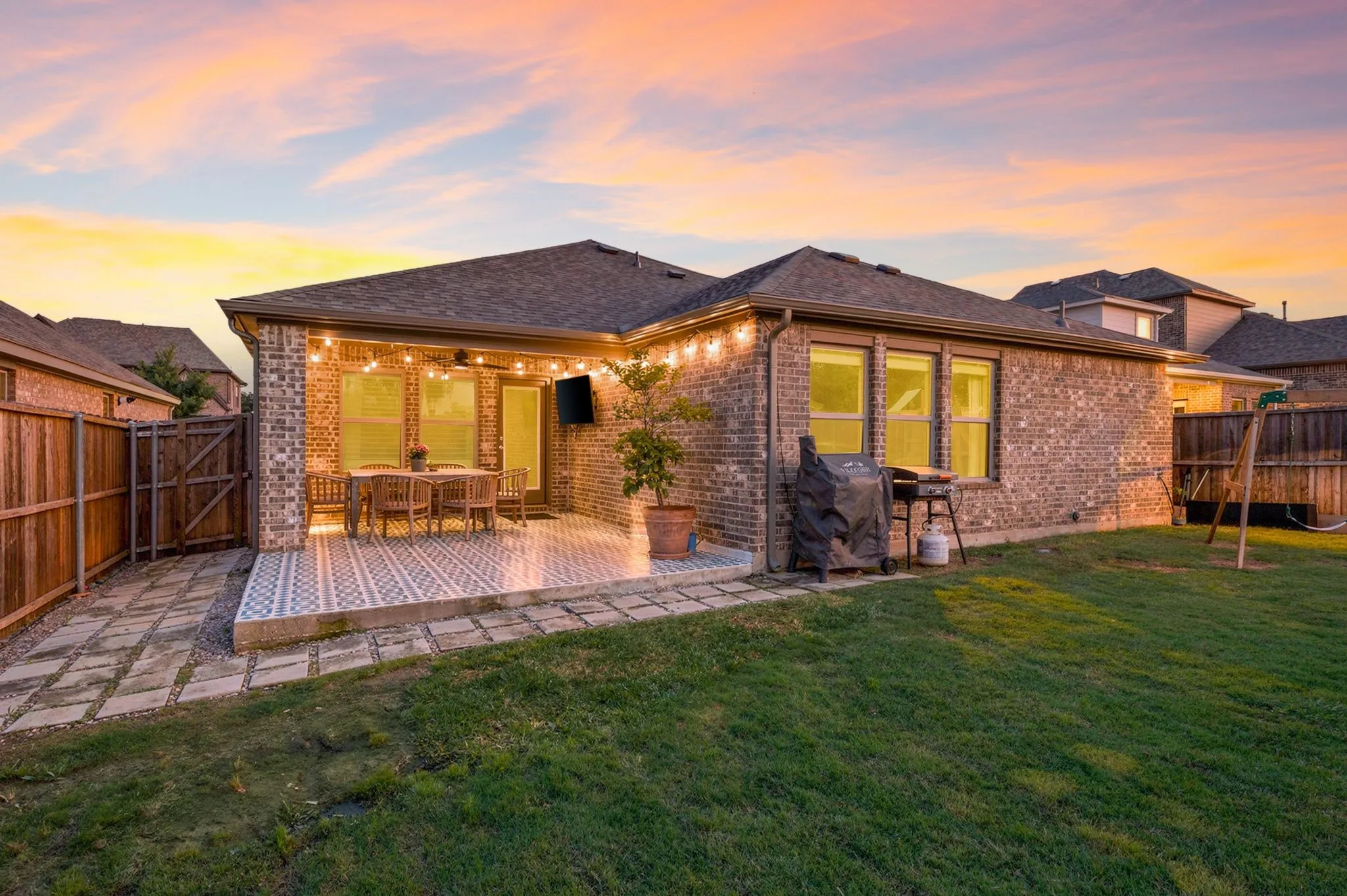 Beautiful home  featuring a covered patio with an extended flooring, and a fenced yard a lush grass lawn....Imagine enjoying your evenings sitting on your back porch!