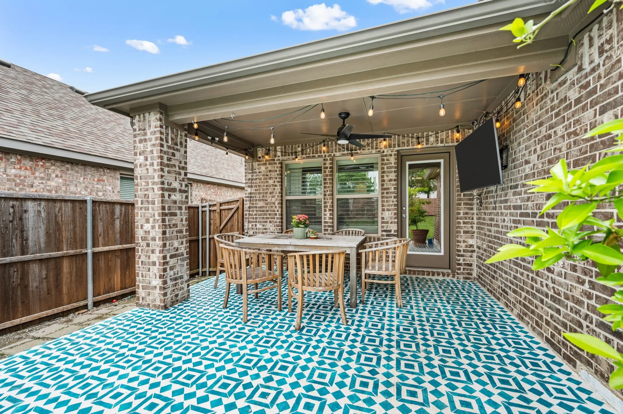 Large covered patio featuring an outdoor ceiling fan and just a wonderful space to enjoy when you are hanging outside!