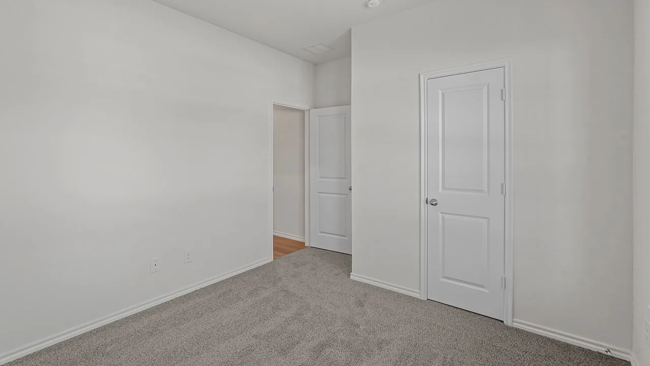 Plush grey carpeting, white interior doors, and neutral wall finishes