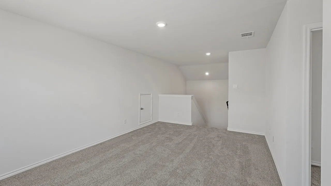 Gray carpeted flooring, recessed lighting, white painted walls