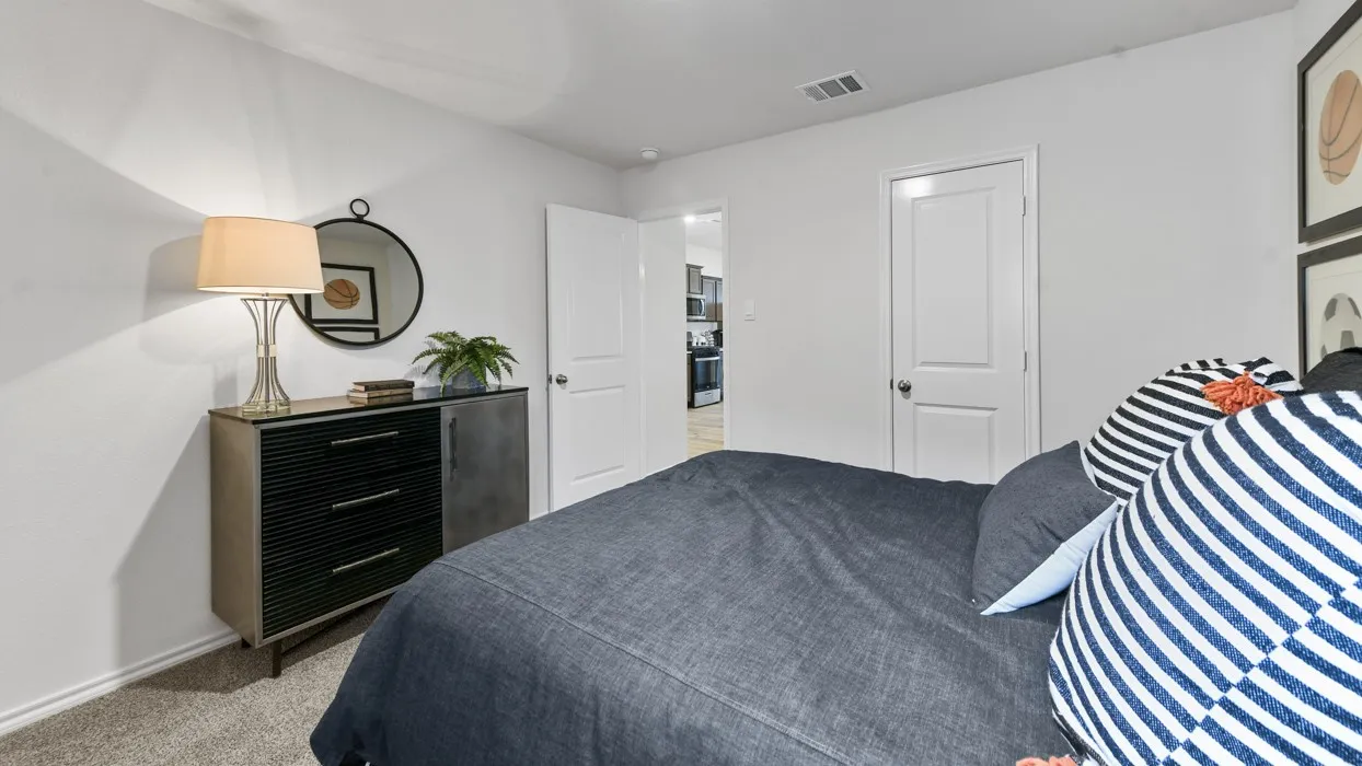 Carpeted room with white walls and a white paneled door