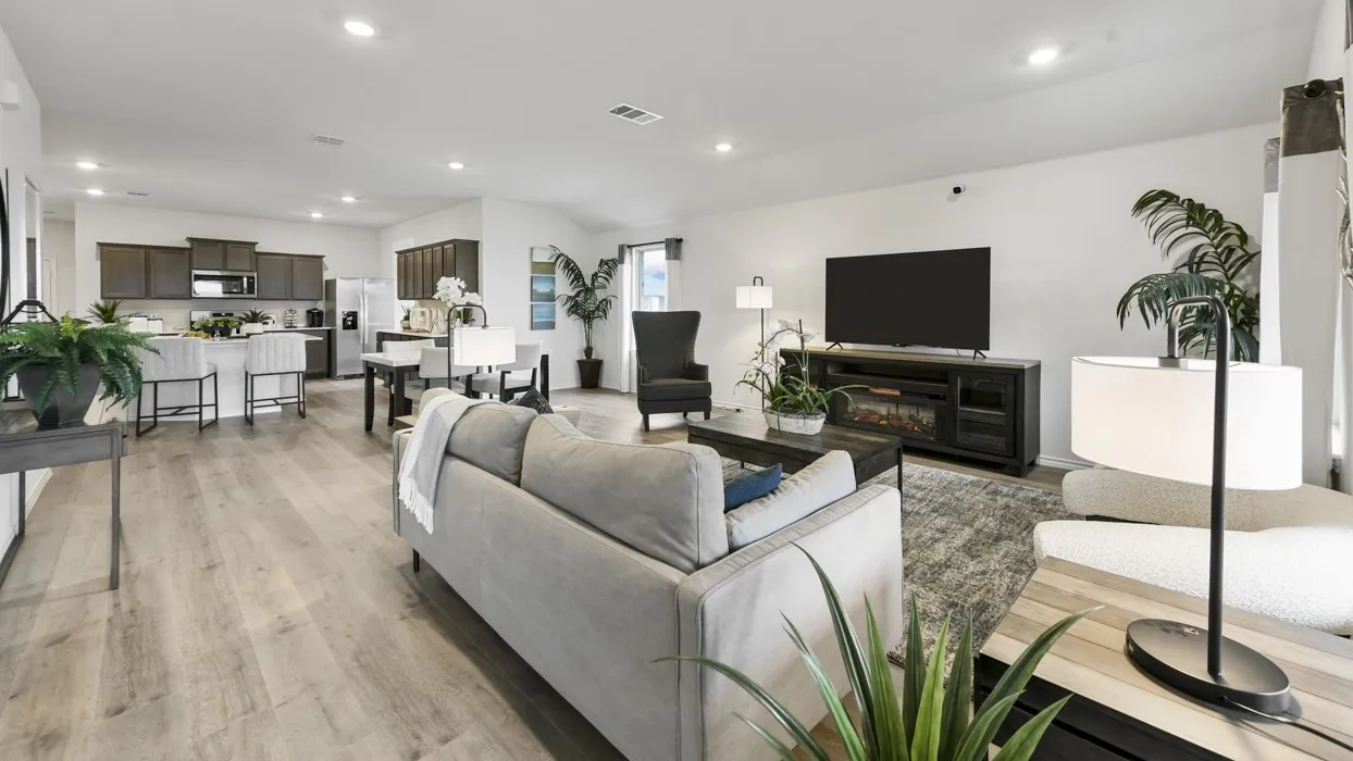 Open-concept living area featuring wood-finish flooring, recessed lighting, and white walls