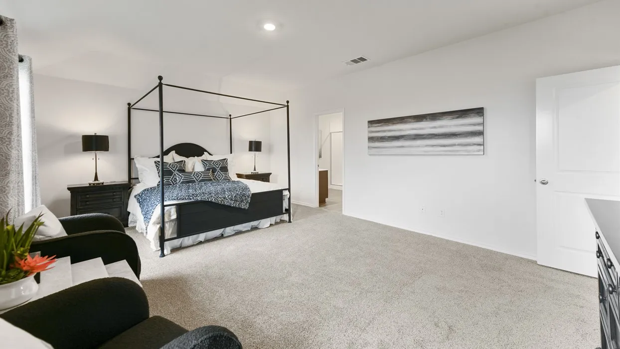 Carpeted room with recessed lighting and a single window featuring patterned curtains