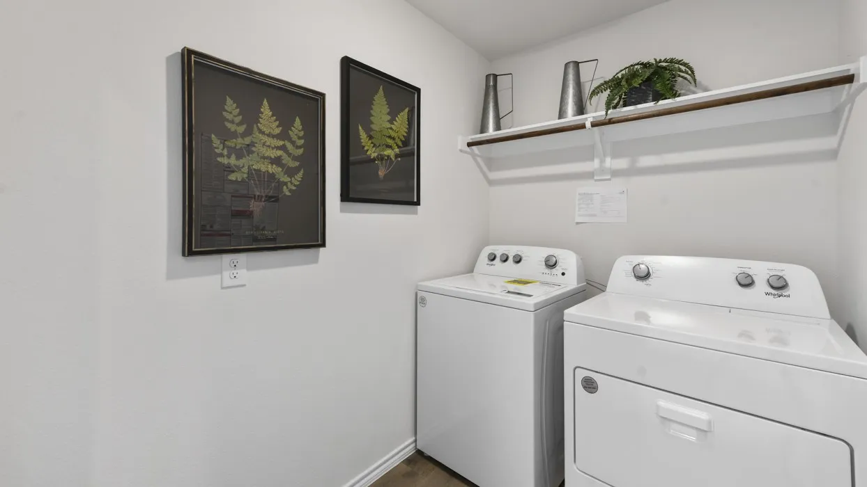 Dedicated utility space featuring a white top-load washing machine and front-load dryer