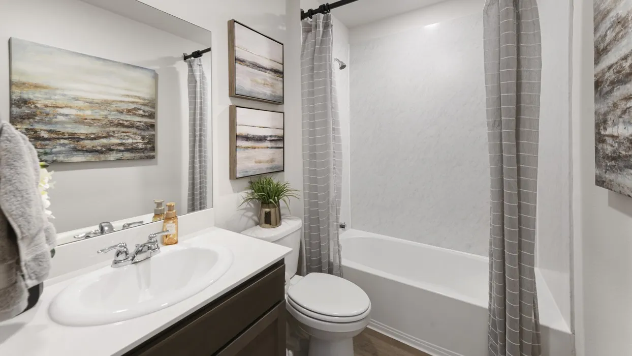 Bathroom featuring a single vanity with a white countertop, a drop-in sink, and chrome fixtures
