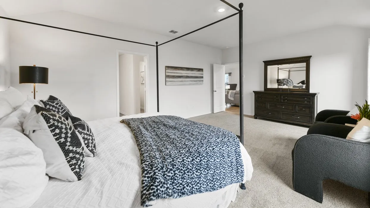 Spacious room featuring vaulted ceilings, light neutral wall tones, and plush carpeting