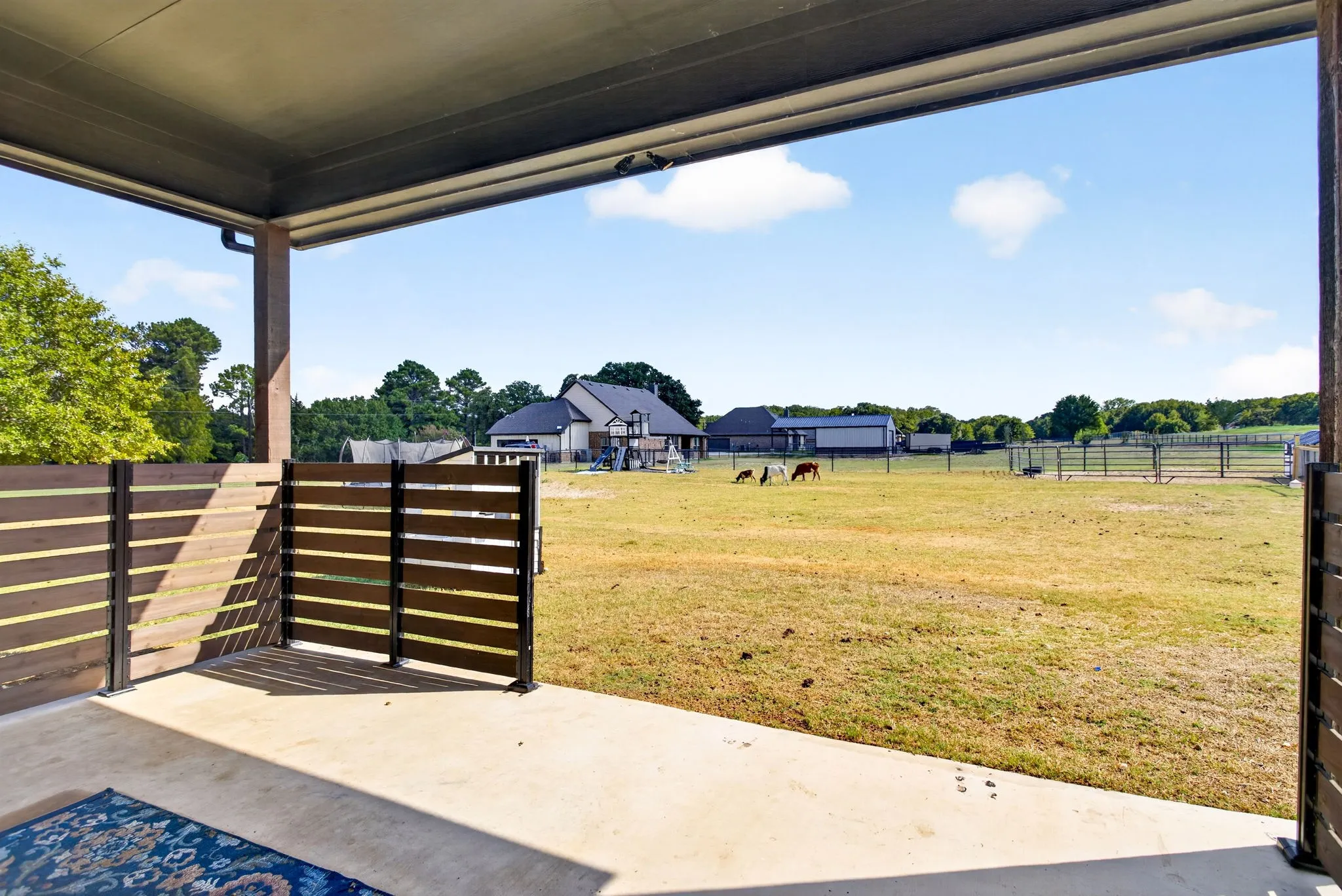 Covered back porch with peaceful views.