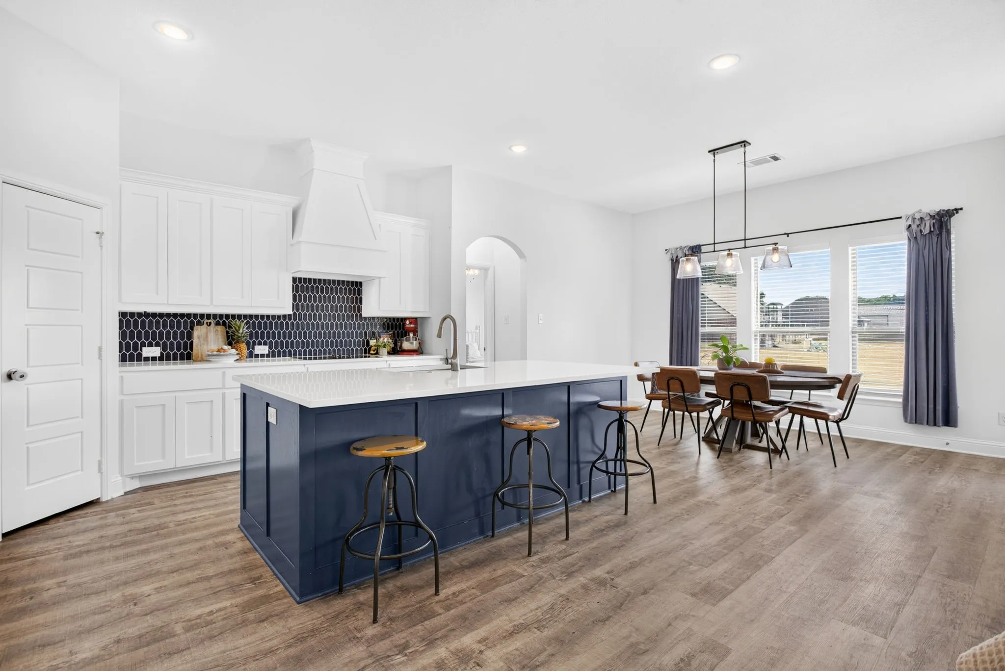 Another view with corner pantry, decorative vent hood and BIG breakfast-dining area.