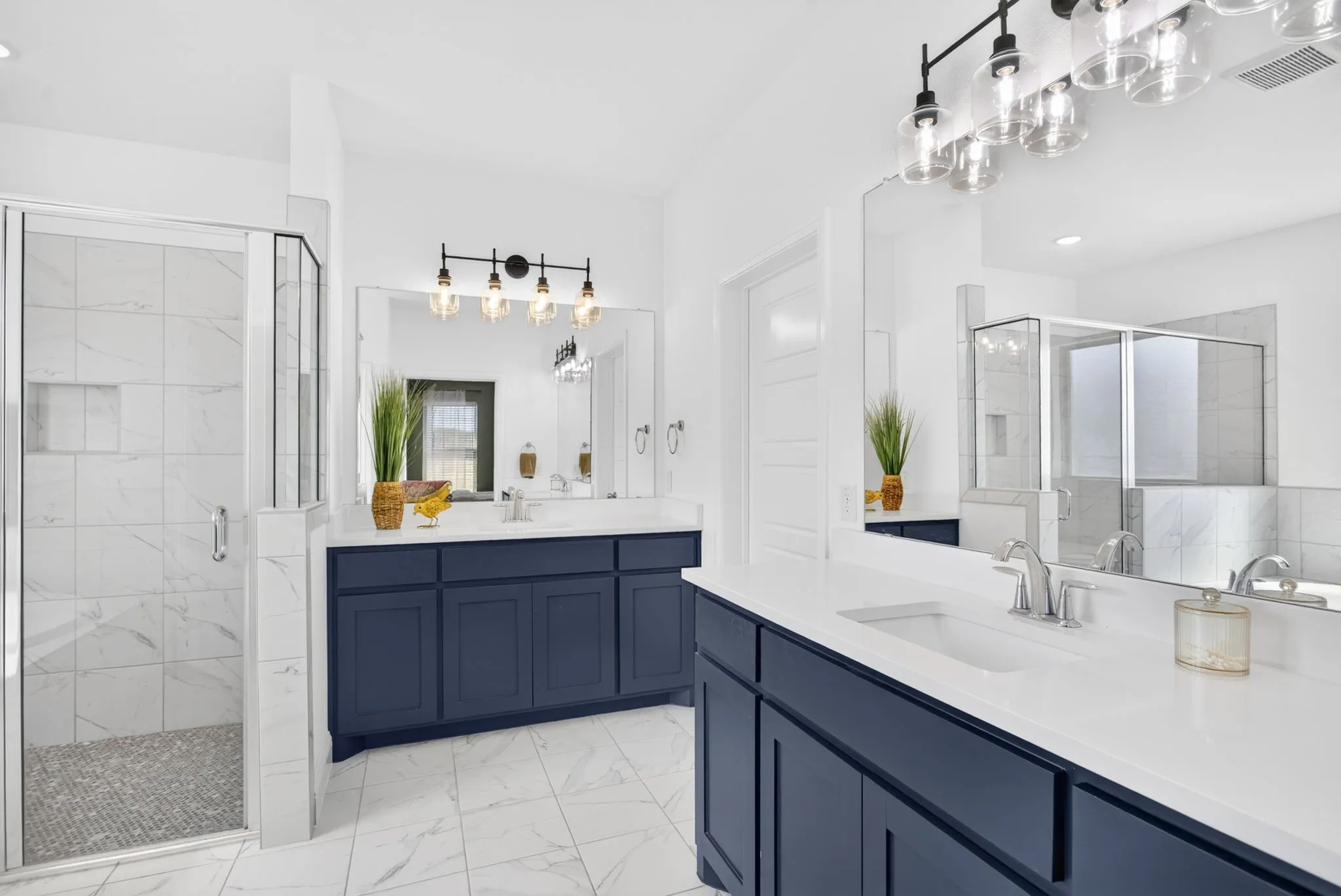 Primary ensuite bathroom with separate vanities and plenty of storage. Big walk-in closet!