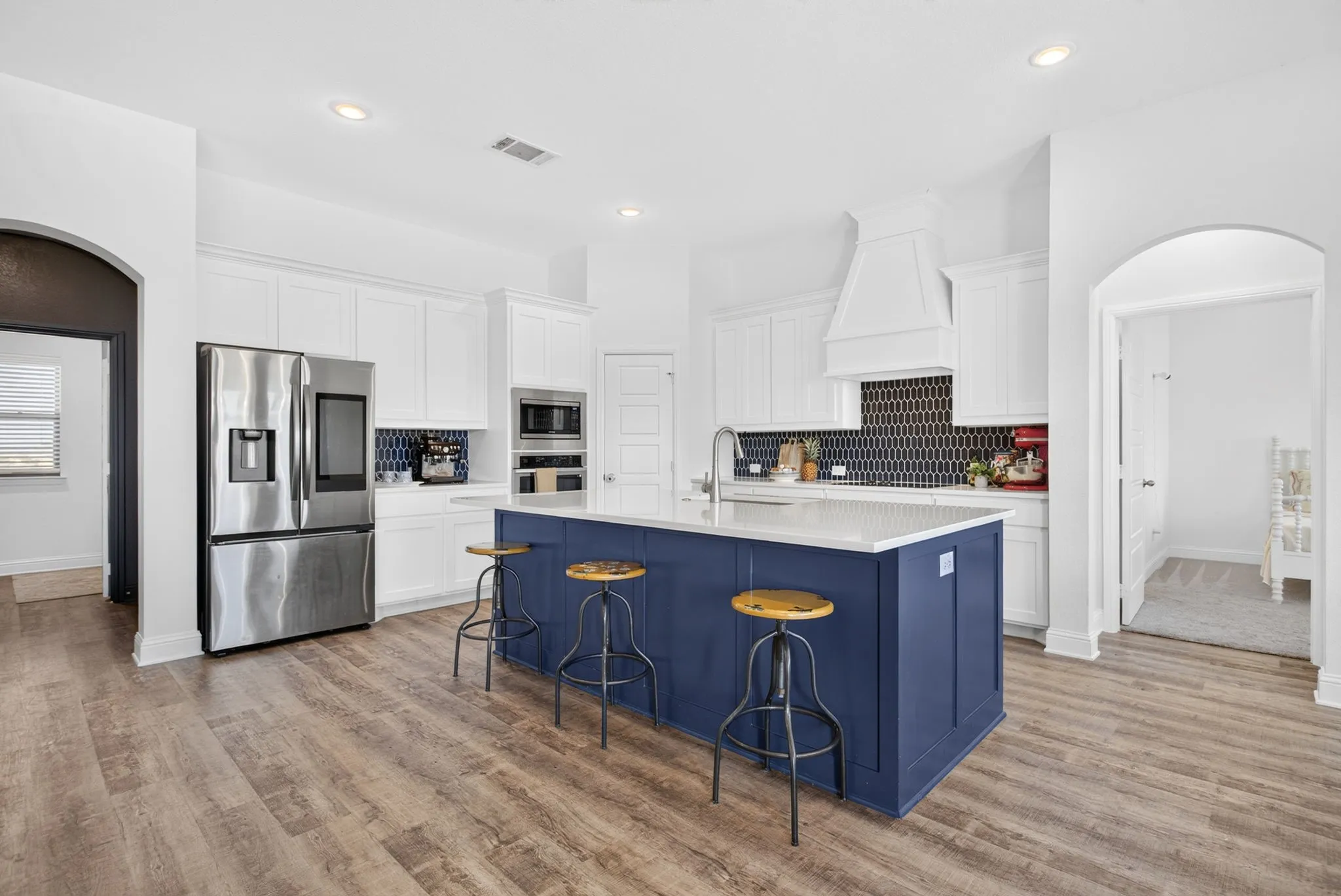 Kitchen feels fresh and bright; big island, lots of counter space.