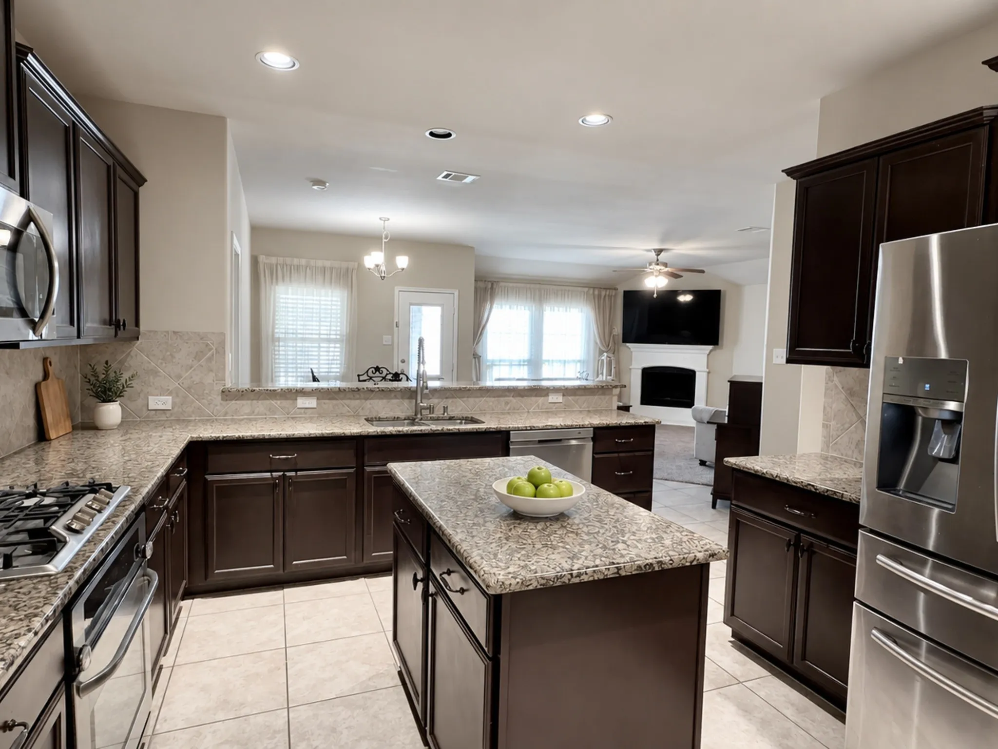 Kitchen with granite countertops, dark wood-finish cabinetry, stainless steel appliances, and a central island