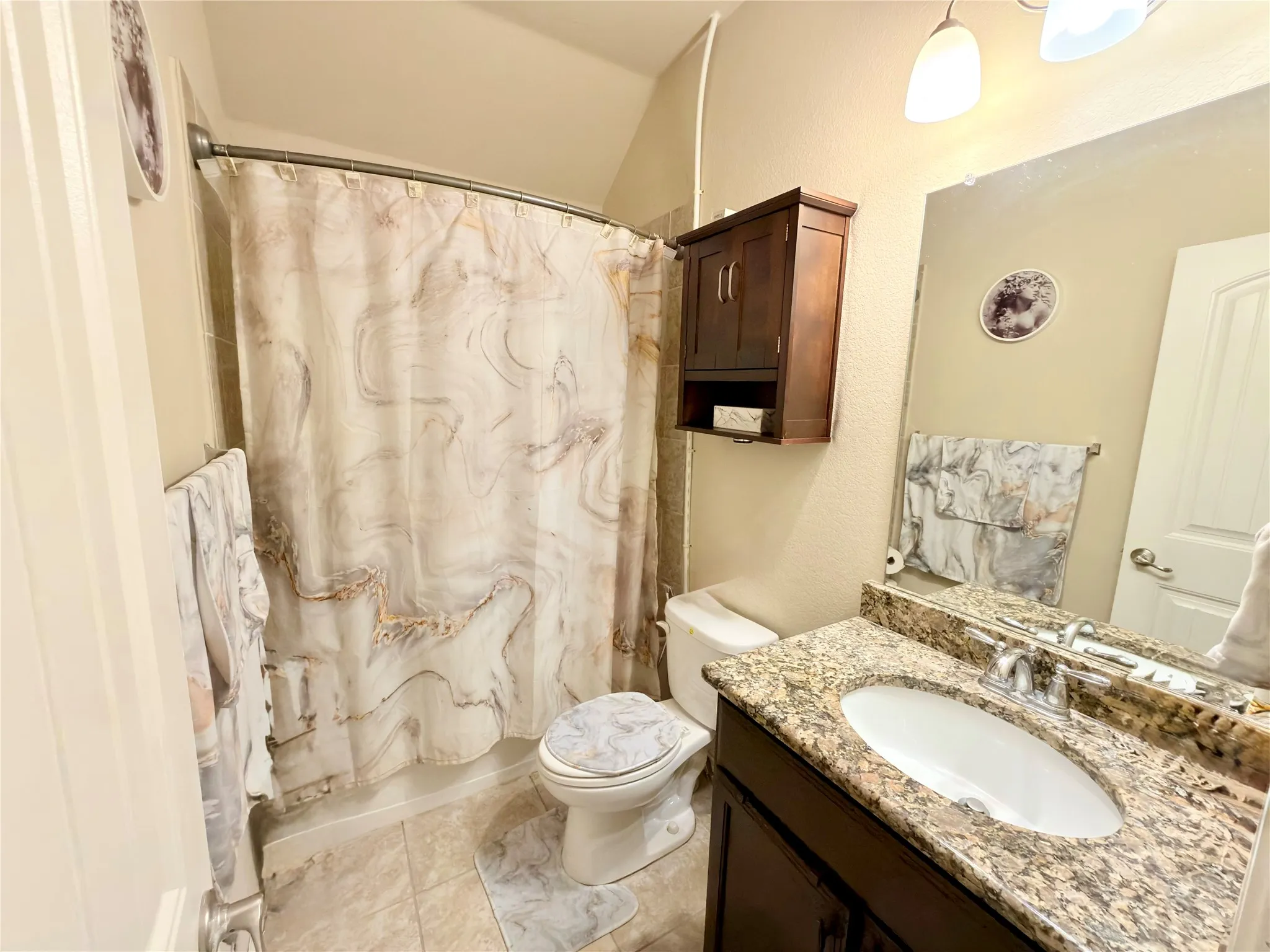 Bathroom with a vanity featuring a granite countertop and an undermount sink