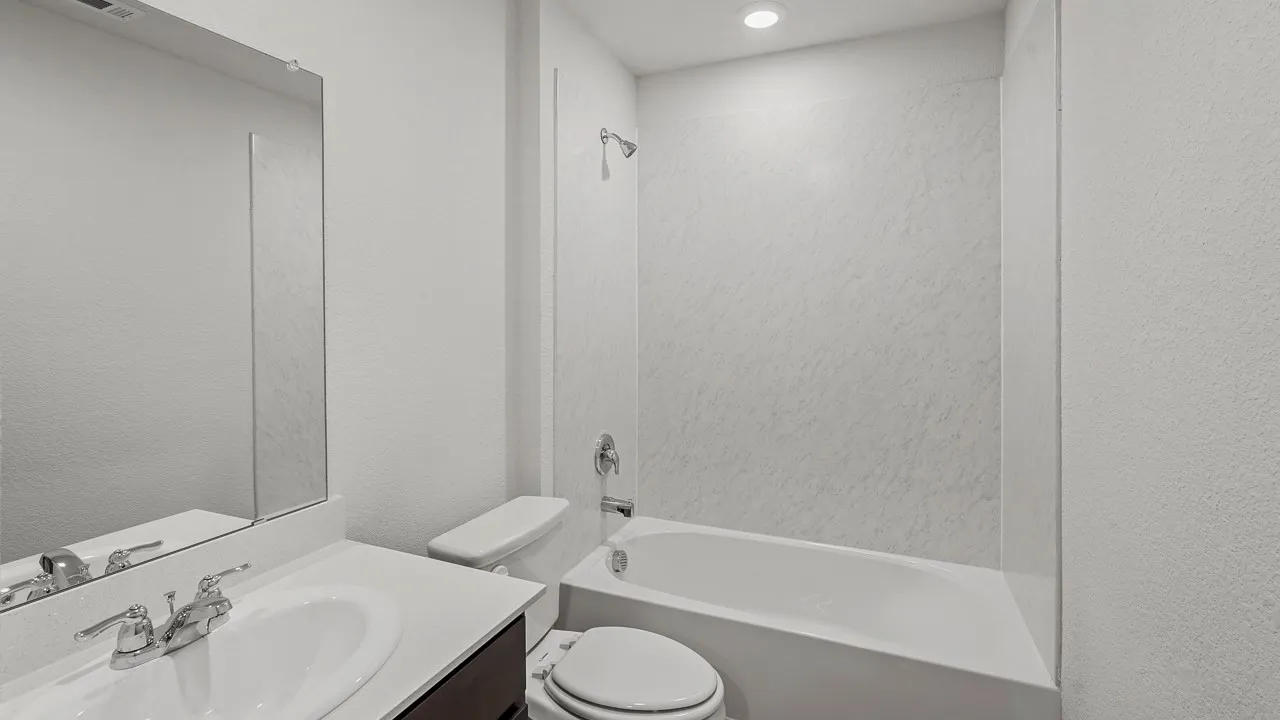 Vanity with integrated sink, chrome-finish faucet, and coordinating mirror