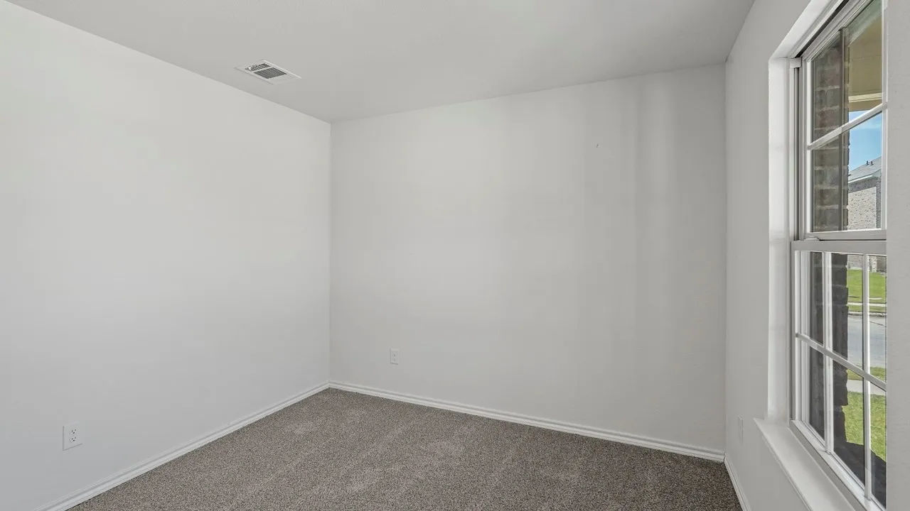 Neutral wall color, carpeted flooring, and a single window with a white frame